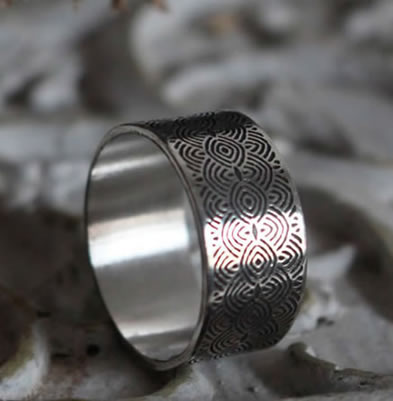 Silver ring of spirals reminiscent of the engraved stones of the Neolithic period