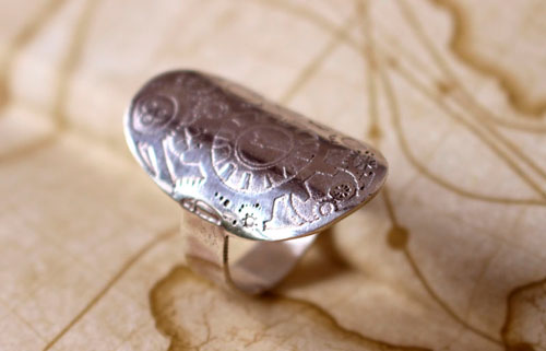 A time travel, steampunk clock and gear ring in sterling silver