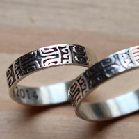 Diapason, Polynesian symbol wedding bands in sterling silver