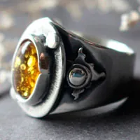 A halo in the darkness, sun ring in sterling silver and amber