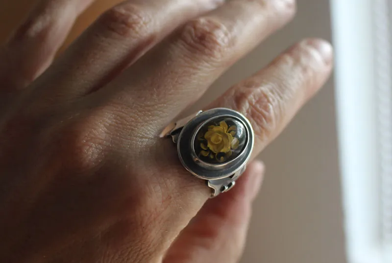 A rose under the stars, intaglio flower ring in silver and amber