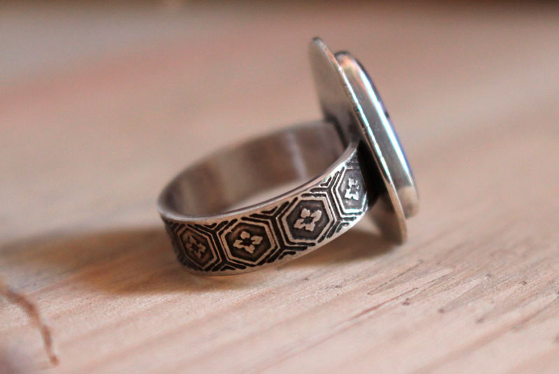 A world in balance, volcano ring in silver and boulder opal