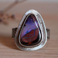 A world in balance, volcano ring in silver and boulder opal