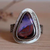 A world in balance, volcano ring in silver and boulder opal
