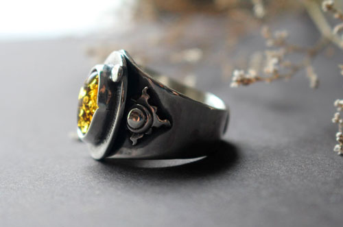 A halo in the darkness, sun ring in sterling silver and Baltic amber