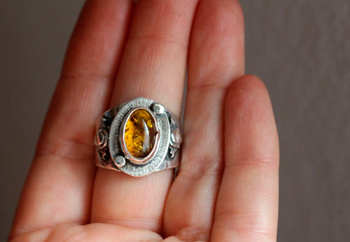 A halo in the darkness, sun ring in sterling silver and Baltic amber