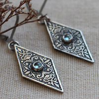 Belladonna, Renaissance floral earrings in silver and blue zircon