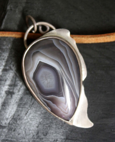 Eagle eye, raptor head pendant in silver and Botswana agate