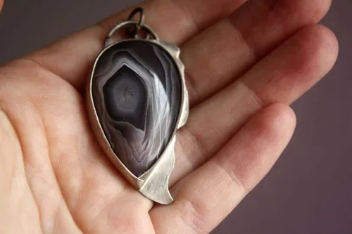 Eagle eye, raptor head pendant in silver and Botswana agate
