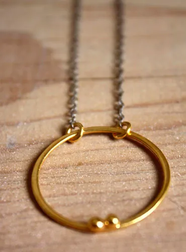 Golden enclosure, couple’s circle necklace in gold and silver
