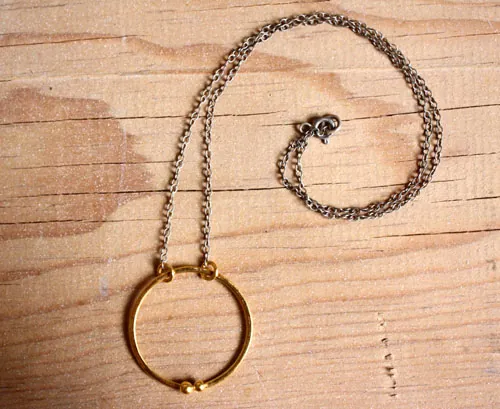 Golden enclosure, couple’s circle necklace in gold and silver