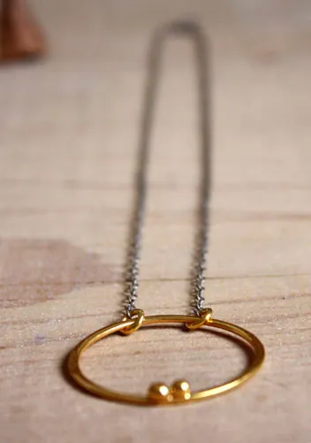 Golden enclosure, couple’s circle necklace in gold and silver