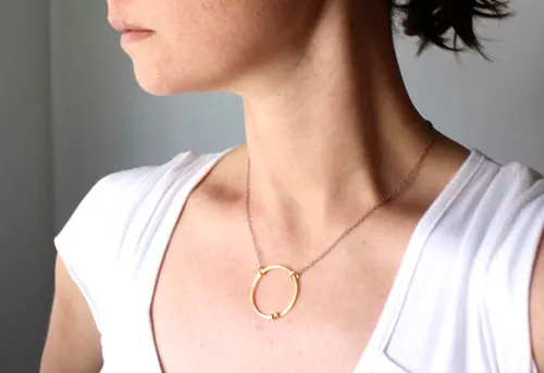 Golden enclosure, couple’s circle necklace in gold and silver