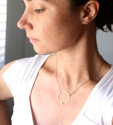 Golden enclosure, couple’s circle necklace in gold and silver