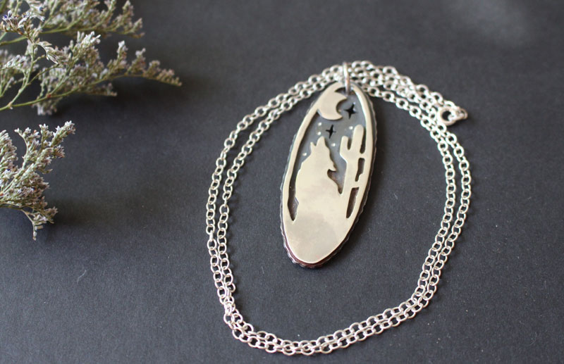 Howling at the moon, desert coyote under the moon necklace in sterling silver