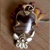 Loha, iron flower pendant in silver and iron jasper