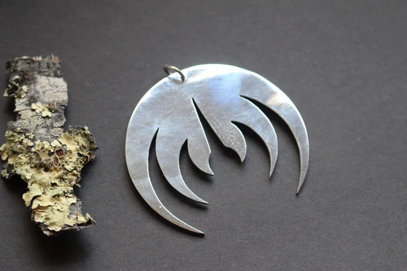 Magma deluxe, rock band logo pendant in sterling silver