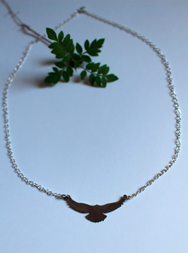 Message, bird symbol necklace in sterling silver