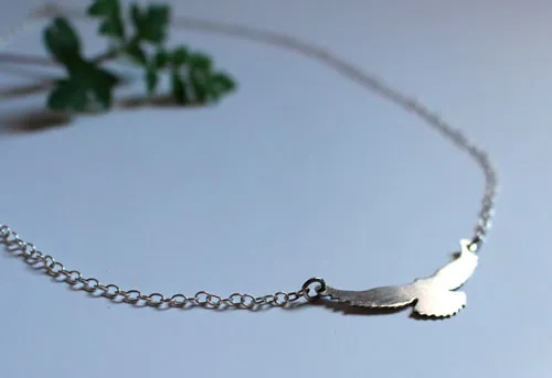 Message, bird symbol necklace in sterling silver