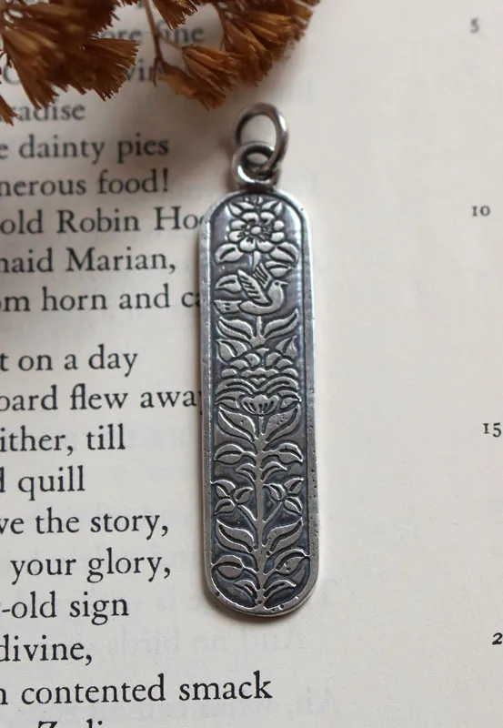 Messenger of life, bird and flower pendant in silver