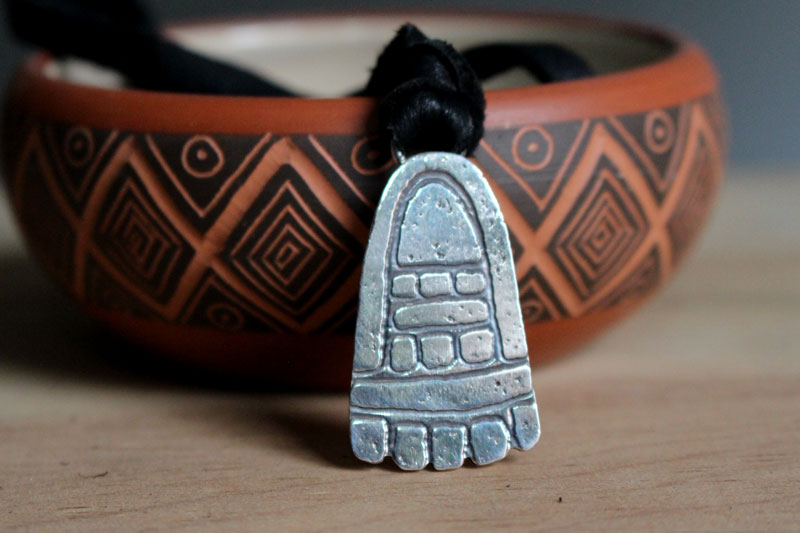 Movement, olmec foot necklace in sterling silver