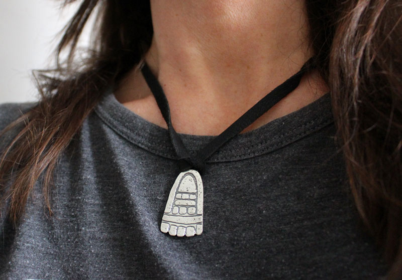 Movement, olmec foot necklace in sterling silver