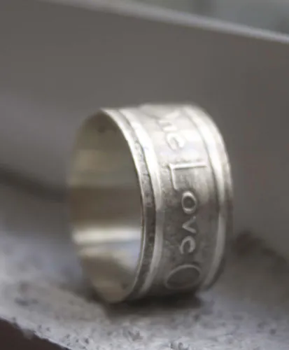 One Love, lyrics from U2’s rock anthem One ring in silver