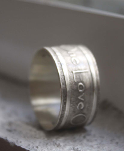 One Love, lyrics from U2’s rock anthem One ring in silver