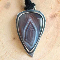 Piercing eye, eagle pendant in silver and Botswana agate
