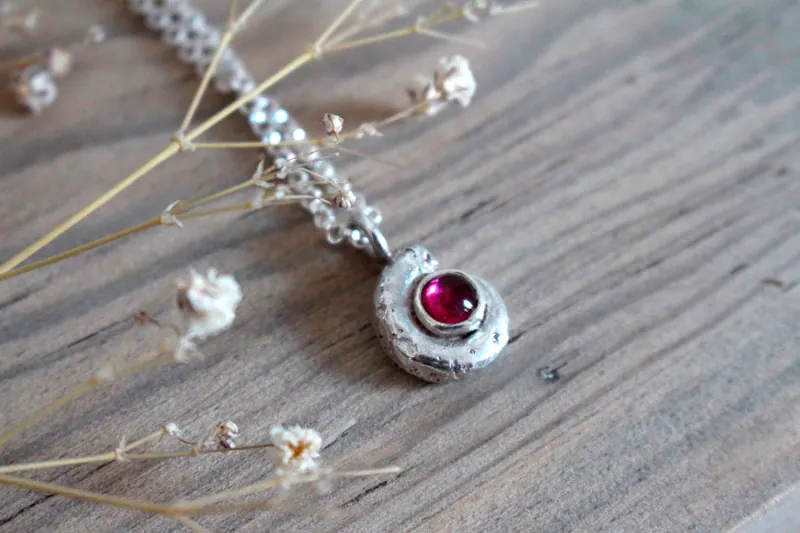 The cradle of life, nautilus Ammonite and birthstone necklace in silver and ruby