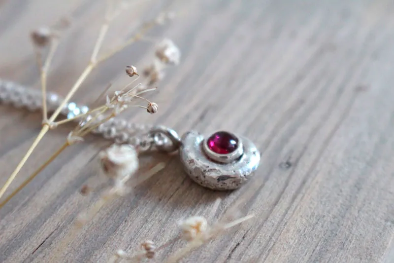 The cradle of life, nautilus Ammonite and birthstone necklace in silver and ruby