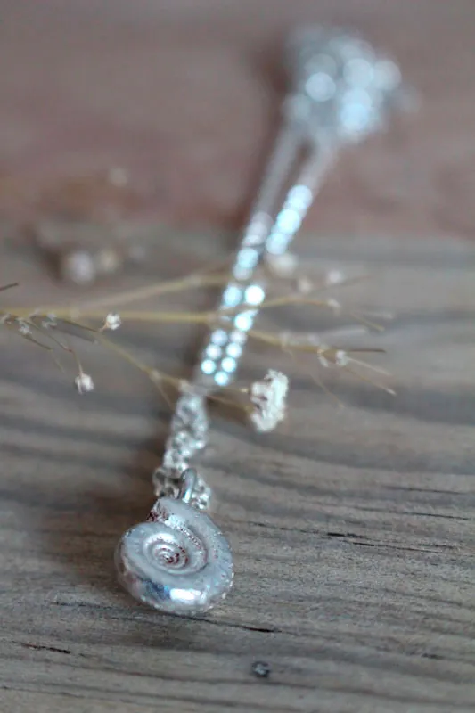 The cradle of life, nautilus Ammonite and birthstone necklace in silver and ruby