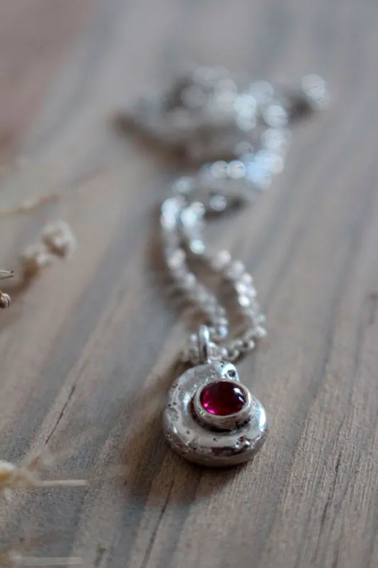 The cradle of life, nautilus Ammonite and birthstone necklace in silver and ruby