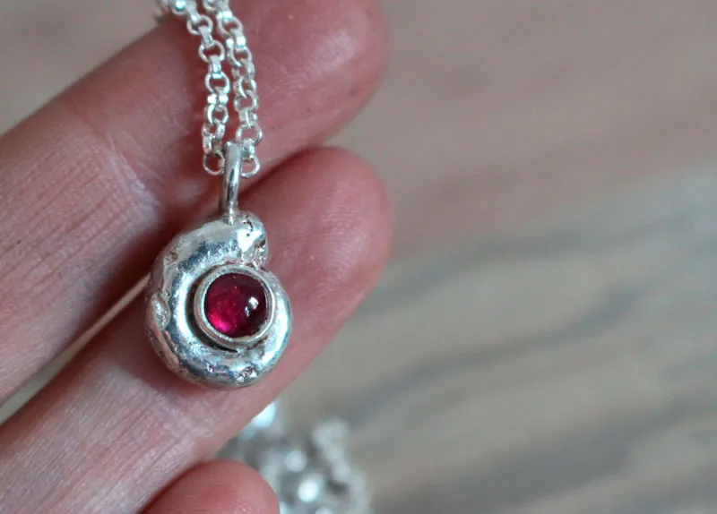 The cradle of life, nautilus Ammonite and birthstone necklace in silver and ruby