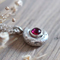 The cradle of life, nautilus ammonite and birthstone necklace in silver and ruby
