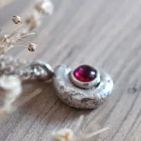 The cradle of life, nautilus Ammonite and birthstone necklace in silver and ruby