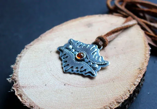 The eye of the earth, tribal mountain necklace in silver and amber