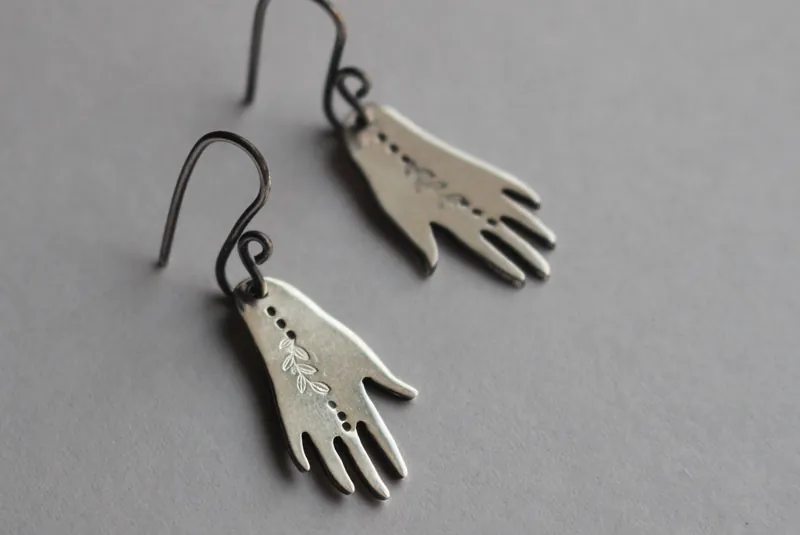 The gift of gaia, hand and leaf earrings in sterling silver
