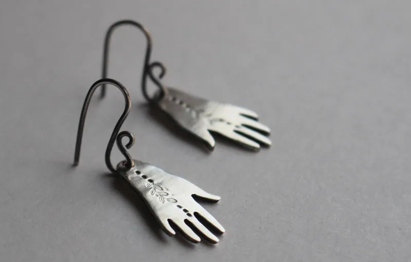 The gift of gaia, hand and leaf earrings in sterling silver
