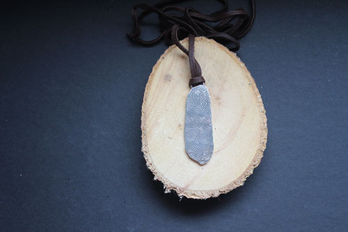 The guardian stone of Newgrange, Neolithic stele from Ireland pendant in silver