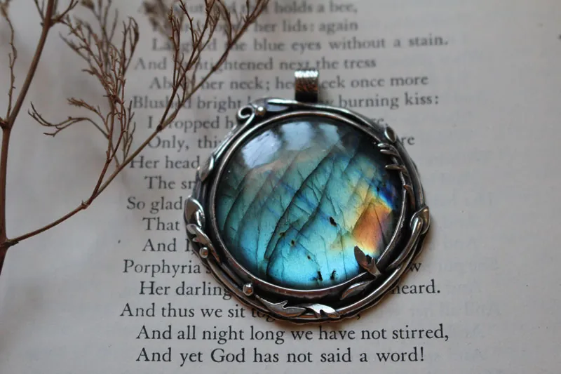 The reflection of the sky, leaves and branches pendant in silver and labradorite