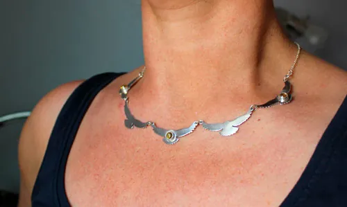 The song of the sun, bird necklace in silver and yellow zircon