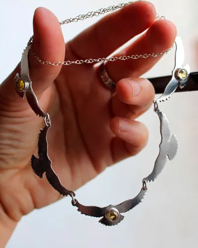 The song of the sun, bird necklace in silver and yellow zircon