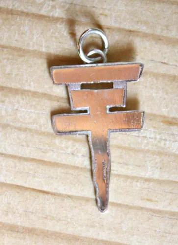 Tokio Hotel, the pop rock band’s cross logo pendant in sterling silver