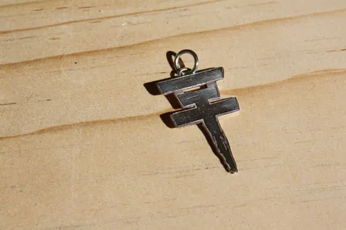 Tokio Hotel, the pop rock band’s cross logo pendant in sterling silver