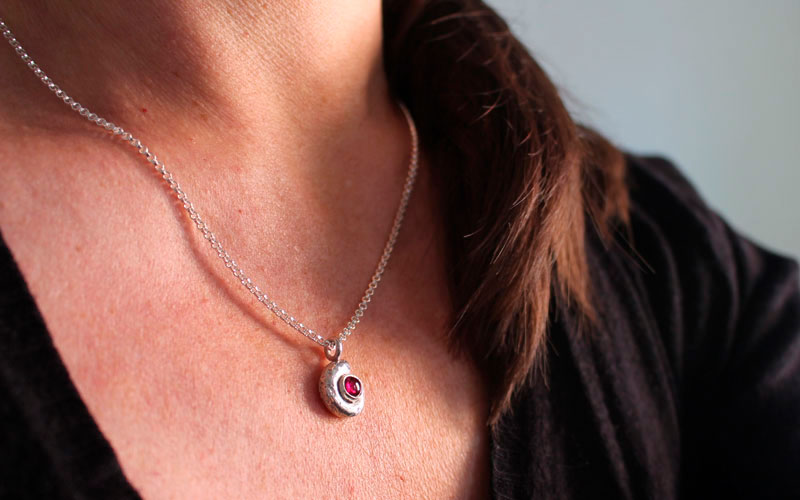 The cradle of life, nautilus ammonite necklace in sterling silver and ruby