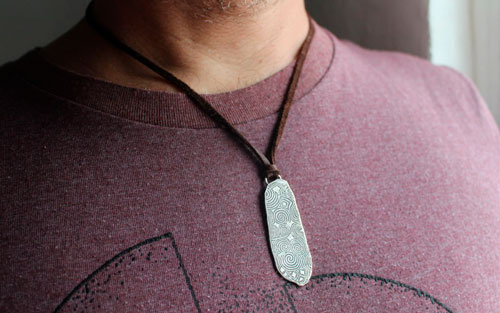 The stone guard of Newgrange, Irish Neolithic stele necklace in silver