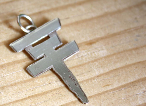 Tokio Hotel, the pop rock band’s cross logo pendant in sterling silver