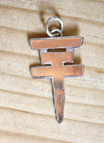 Tokio Hotel, the pop rock band’s cross logo pendant in sterling silver