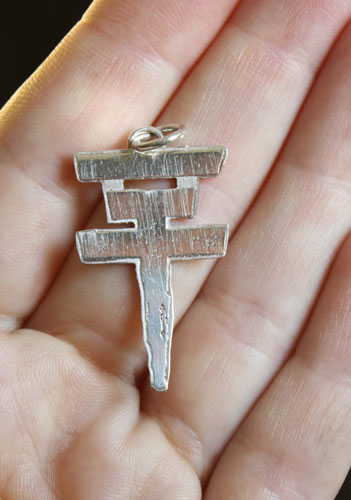 Tokio Hotel, the pop rock band’s cross logo pendant in sterling silver